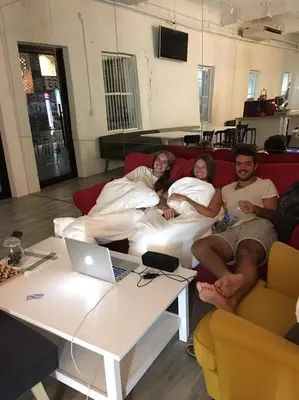 a group of people sitting on a couch with a laptop at Norn Yaowarat Hotel in Bangkok