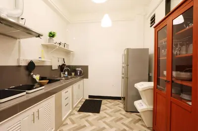 a kitchen with a sink and a refrigerator at Neveu Premier Residence : Ratchada in Bangkok