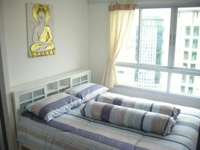 a bedroom with two beds and a window at Bangkok view in Pinklao in Bangkok