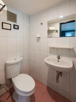 a bathroom with a toilet and a sink at BB House Phra Athit บีบี เฮ้าส์ พระอาทิตย์ in Bangkok