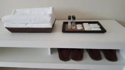 a white table with a tray of towels and shoes at Popular Condo P1 in Nonthaburi