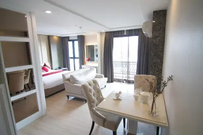 a living room with a dining table and a living room at Hope Land Hotel Sukhumvit 8 in Bangkok