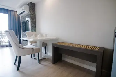 a room with a desk and a table and a chair at Hope Land Hotel Sukhumvit 8 in Bangkok