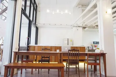 a dining room with a table and chairs at Boon Street Hostel in Bangkok