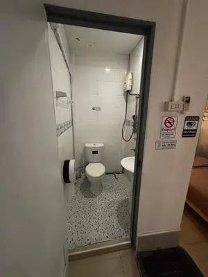 a small bathroom with a toilet and a shower at La Locanda in Bangkok