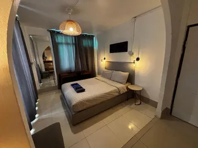 a small bedroom with a bed and a mirror at La Locanda in Bangkok