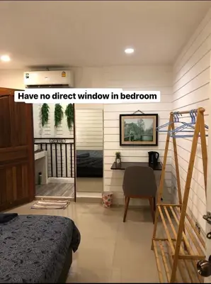 a bedroom with a bed and a staircase in a room at La Locanda in Bangkok