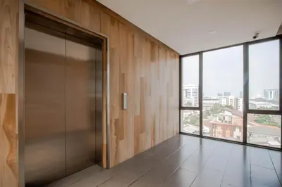 an elevator door in a building with a view at Kepler Residence Bangkok in Bangkok