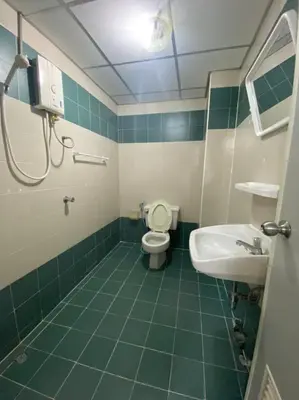 a bathroom with a toilet and a sink at City Residence in Bangkok