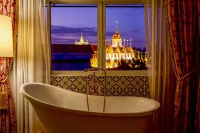 a bath tub in a bathroom with a window at Siam Champs Elyseesi Unique Hotel in Bangkok