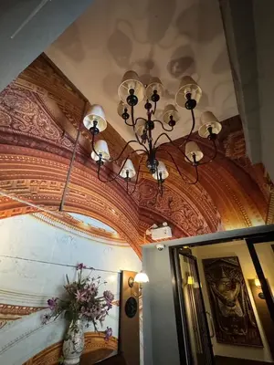 a chandelier hanging from a ceiling in a room at Siam Champs Elyseesi Unique Hotel in Bangkok