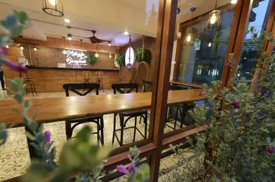 a restaurant with a wooden table and some plants at Adagio Bangkok in Bangkok
