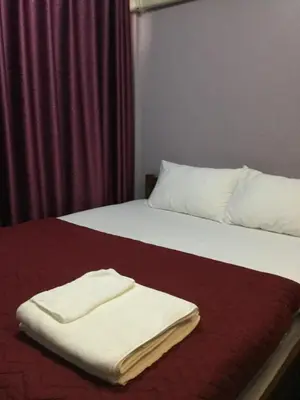 two towels are sitting on top of a bed at Donmuang At Last in Bangkok