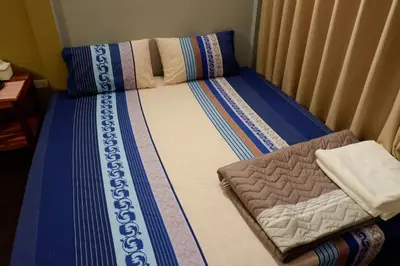 a small bed in a room with at Donmuang At Last in Bangkok