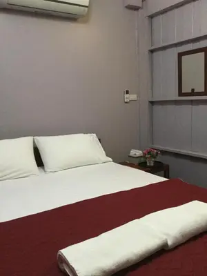 a bedroom with a large white bed with a red blanket at Donmuang At Last in Bangkok