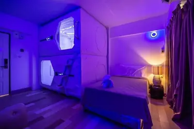 a purple room with a bed with a teddy bear on it at Sudyod Apartment in Bangkok
