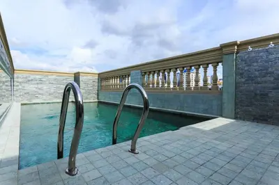 a swimming pool with two metal rails next to a building at The LA49 Hotel in Bangkok