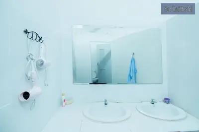 a bathroom with two sinks and a mirror at Zee Thai Hostel in Bangkok