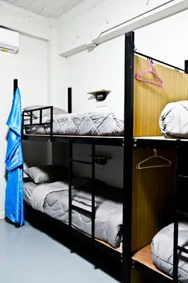 a room with two bunk beds and a blue umbrella at Zee Thai Hostel in Bangkok