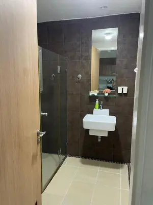 a bathroom with a sink and a shower at Studio in Haven in Bangkok