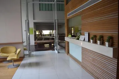 an office lobby with a reception counter and chairs at Studio in Haven in Bangkok