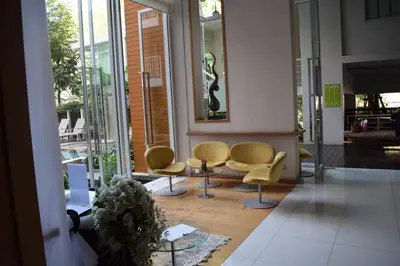 a lobby with chairs and a table in a building at Studio in Haven in Bangkok