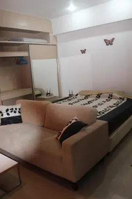 a living room with a couch and a bed at Studio in Haven in Bangkok