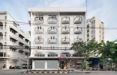 a white building with balconies on the side of it at Hotel PaPa Bangkok Siriraj in Bangkok