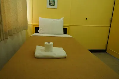 a bed with a roll of toilet paper on it at Yes Kaosan in Bangkok