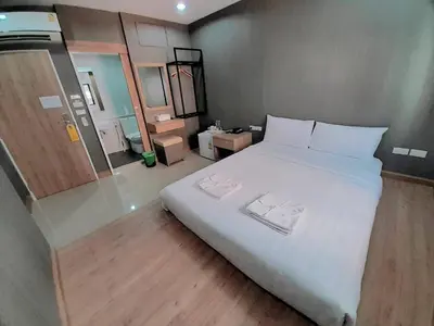 a bedroom with a large white bed in a room at Collection O Pratunam 19 Hotel in Bangkok