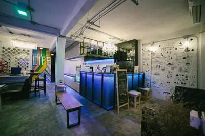 a restaurant with blue booths and a table and chairs at Diff Hostel in Bangkok