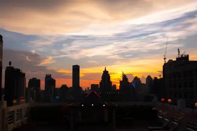 a view of a city skyline at sunset at Zenith Sukhumvit Hotel, Bangkok in Bangkok