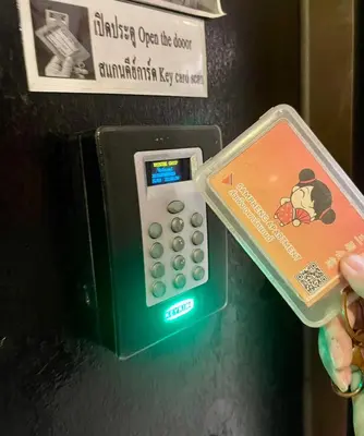 a pay phone with a winnie the pooh on it at Sampheng Apartment in Bangkok