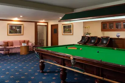 a room with a pool table in a hotel room at The Emerald Hotel in Bangkok