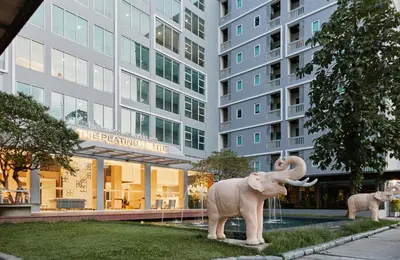 a statue of an elephant in front of a building at Sunday Platinum Suites in Bangkok