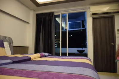 a bedroom with a bed and a large window at Family Suite Room Pratunam in Bangkok