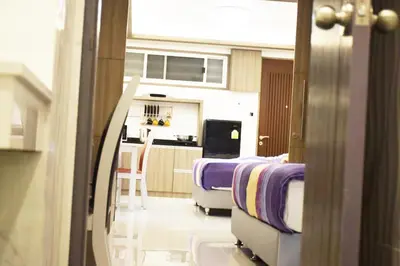 a hospital room with two beds and a kitchen at Family Suite Room Pratunam in Bangkok