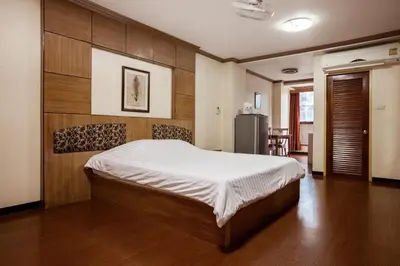 a bedroom with a large bed in a room at The Aiyapura Bangkok in Bangkok