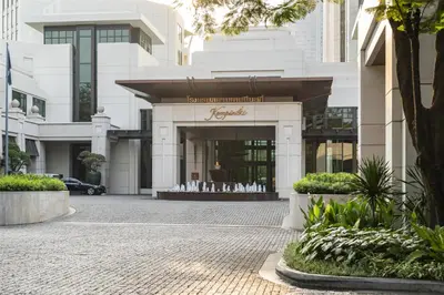 a building with a store in the middle of a street at Siam Kempinski Hotel Bangkok in Bangkok