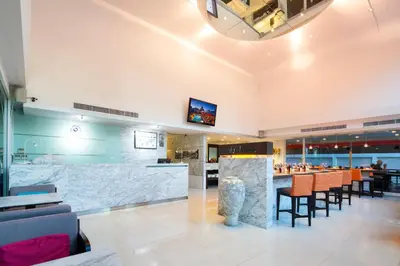 a restaurant with a bar with stools at Hotel Solo, Sukhumvit 2, Bangkok - SHA Extra Plus in Bangkok