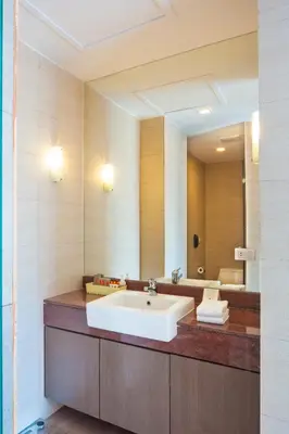 a bathroom with a sink and a large mirror at Hotel Solo, Sukhumvit 2, Bangkok - SHA Extra Plus in Bangkok