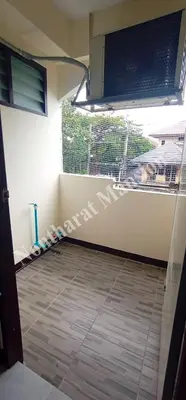 a room with a window and a tiled floor at Nontharat Mansion in Nonthaburi