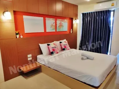 a small bedroom with a bed and a window at Nontharat Mansion in Nonthaburi