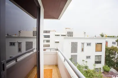 a balcony with a view of a white building at New Siam Palace Ville Hotel in Bangkok