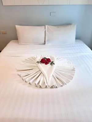 a white bed with a heart made out of roses at Nantra de Comfort in Bangkok