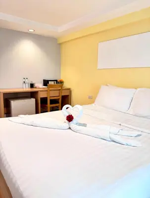 a hotel room with a bed with a towel on it at Nantra de Comfort in Bangkok