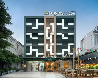 a large black building with a sign on it at The Legacy Hotel Nana Sukhumvit, Aspira Collection in Bangkok