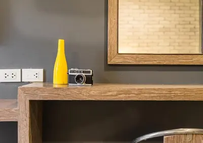 a yellow bottle sitting on top of a table with a camera at Ton Aor Place Hotel in Bangkok
