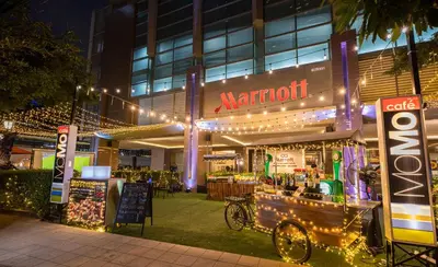 a restaurant with a bike parked in front of a building at Sathorn Vista, Bangkok - Marriott Executive Apartments in Bangkok