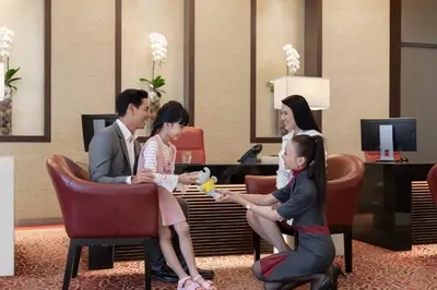 a group of people sitting in chairs in a lobby at Marriott Executive Apartments Sukhumvit Park, Bangkok in Bangkok